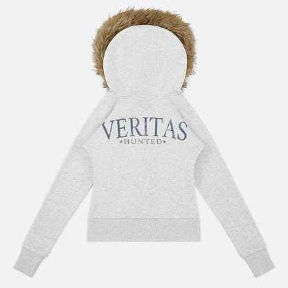 A light heather gray zip-up hoodie shown from the back, featuring a brown faux-fur trimmed hood and 'VERITAS HUNTED' printed in navy blue across the upper back.