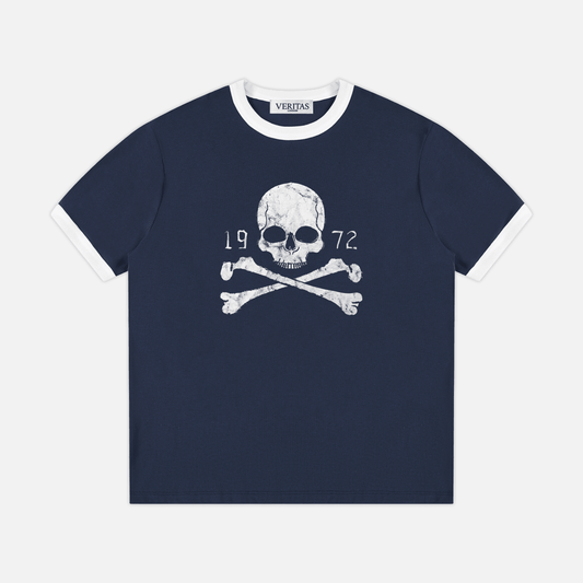 A navy blue ringer t-shirt with white trim on the collar and cuffs, featuring a white skull and crossbones graphic with '1972' text on the chest, by the brand VERITAS.