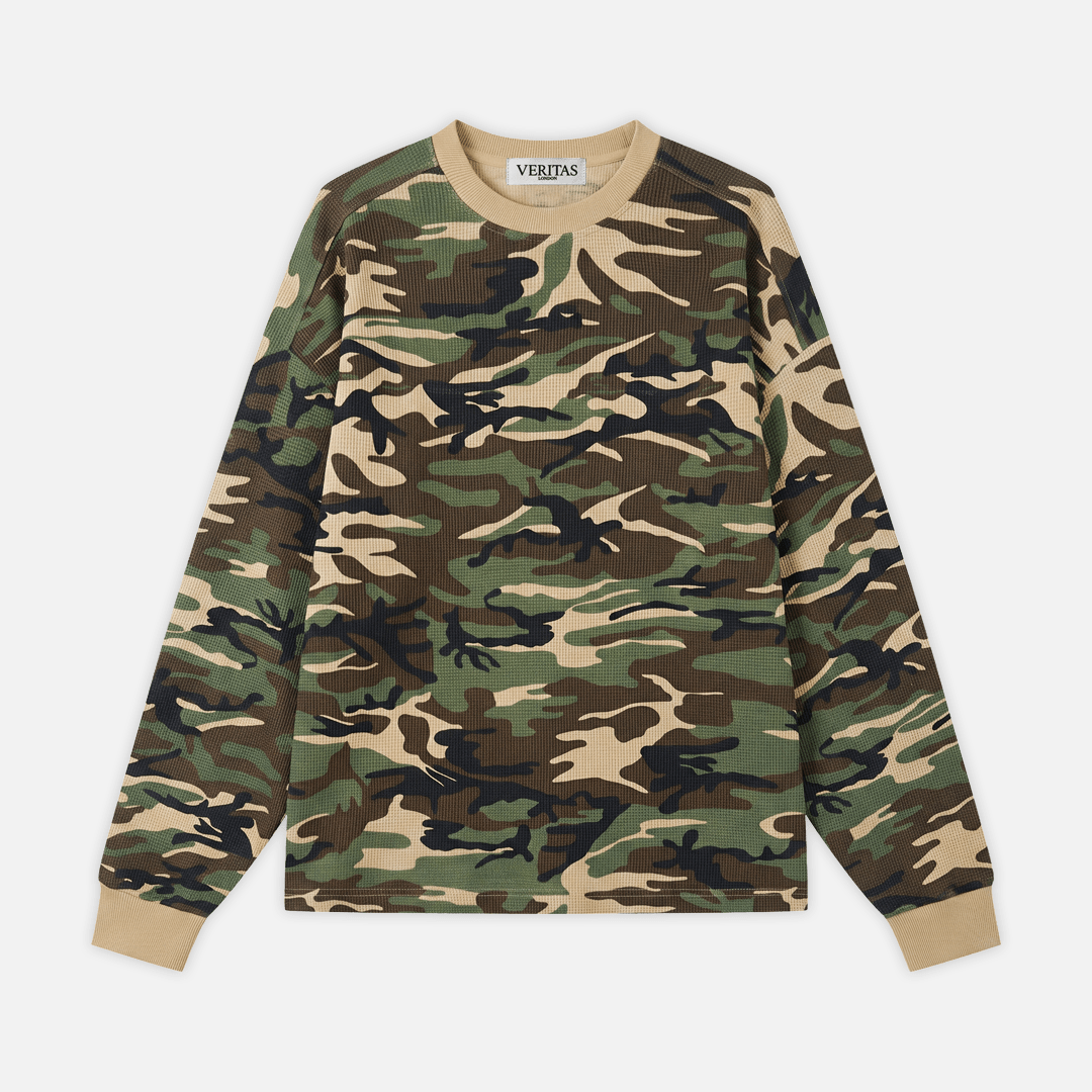 A long-sleeve crewneck sweatshirt featuring a classic green, brown, black, and beige camouflage pattern, with solid beige ribbed collar, cuffs, and hem. The brand name 'VERITAS' is visible on the inner neck label.