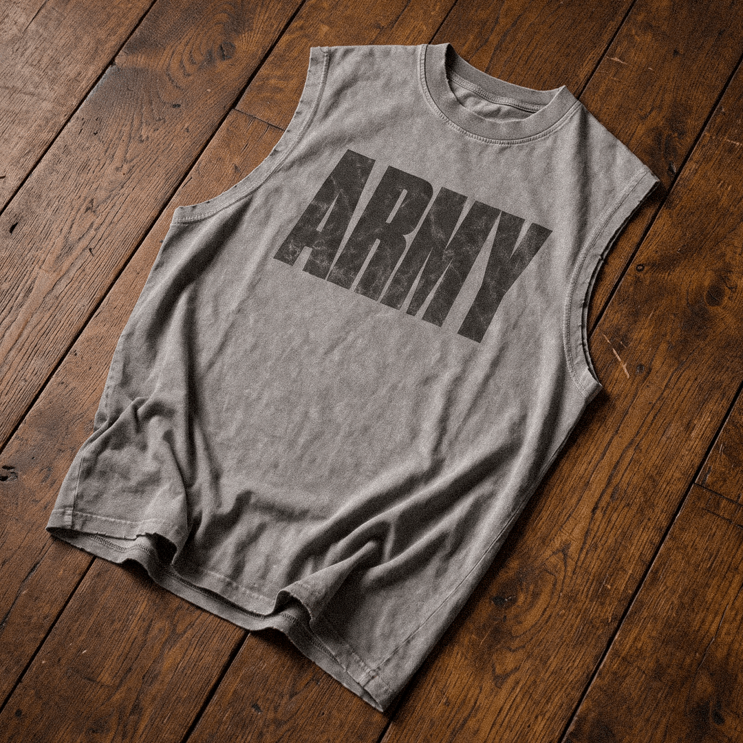 A heather gray sleeveless muscle t-shirt with a distressed black 'ARMY' graphic printed on the chest, laid flat on a rustic dark wood plank floor.