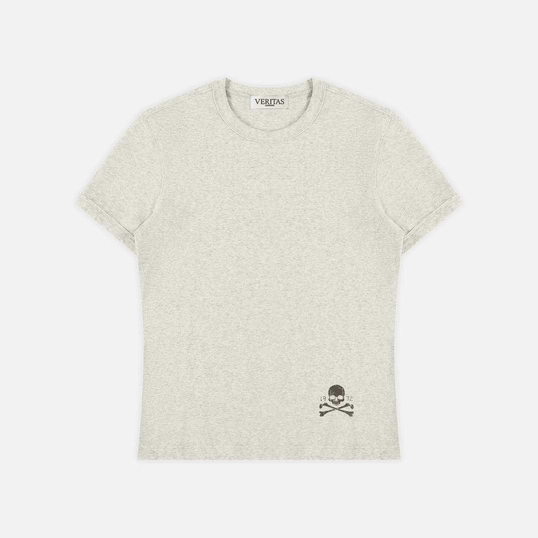 A light heather gray crewneck t-shirt with a small black skull and crossbones graphic on the bottom right, displayed flat against a light gray background.