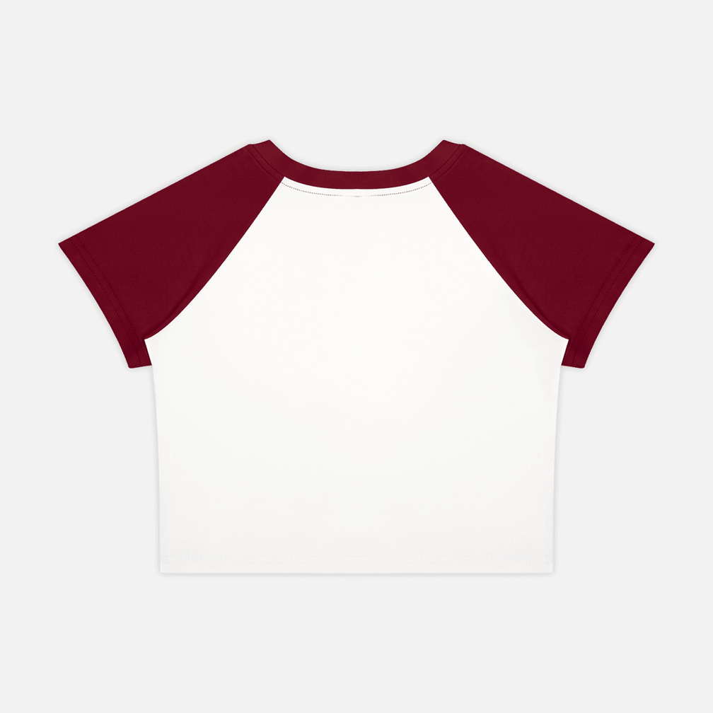 A short-sleeve raglan crop top with a white body and dark burgundy sleeves, shown flat against a light gray background.