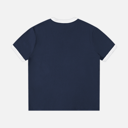 A navy blue short-sleeve t-shirt with white contrast trim on the collar and sleeve cuffs, shown from the back against a light gray background.