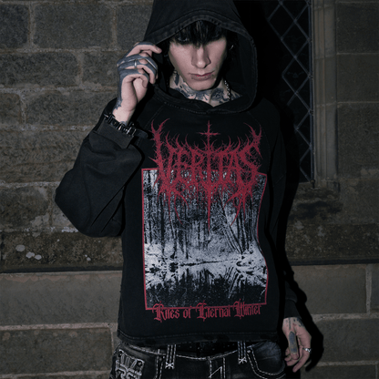 Person wearing a black hoodie with red and white graphic design against a stone wall.