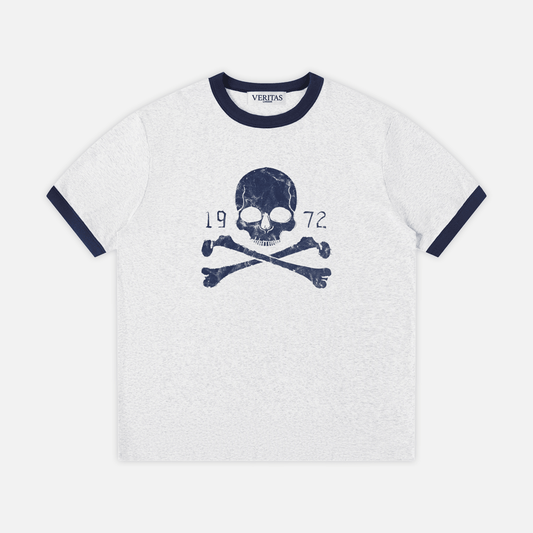 A gray heather ringer t-shirt with navy blue trim on the crew neck and sleeve cuffs, featuring a navy blue skull and crossbones graphic with '1972' text on the chest. VERITAS woven neck tag.